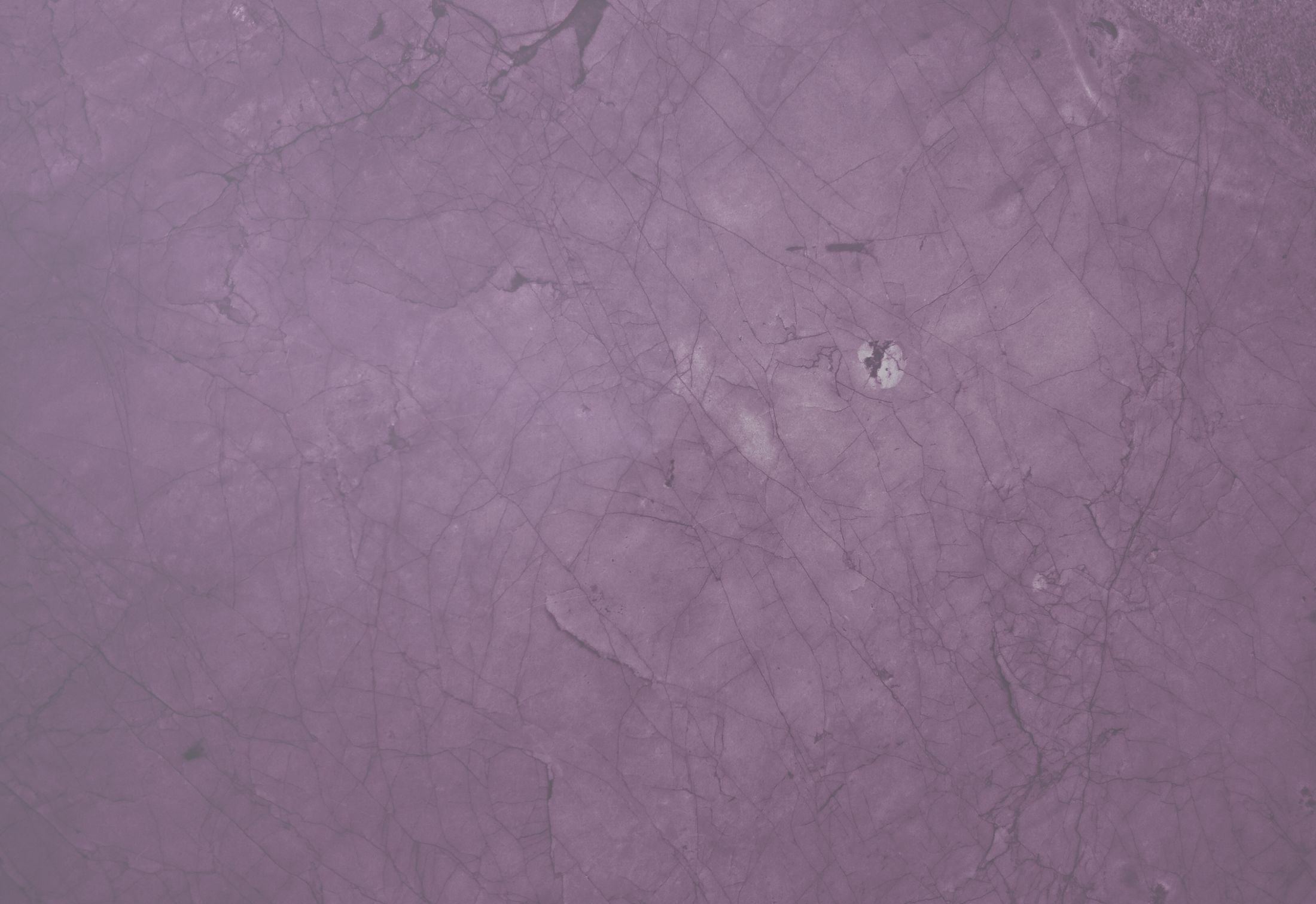 Purple textured surface with faint cracks.