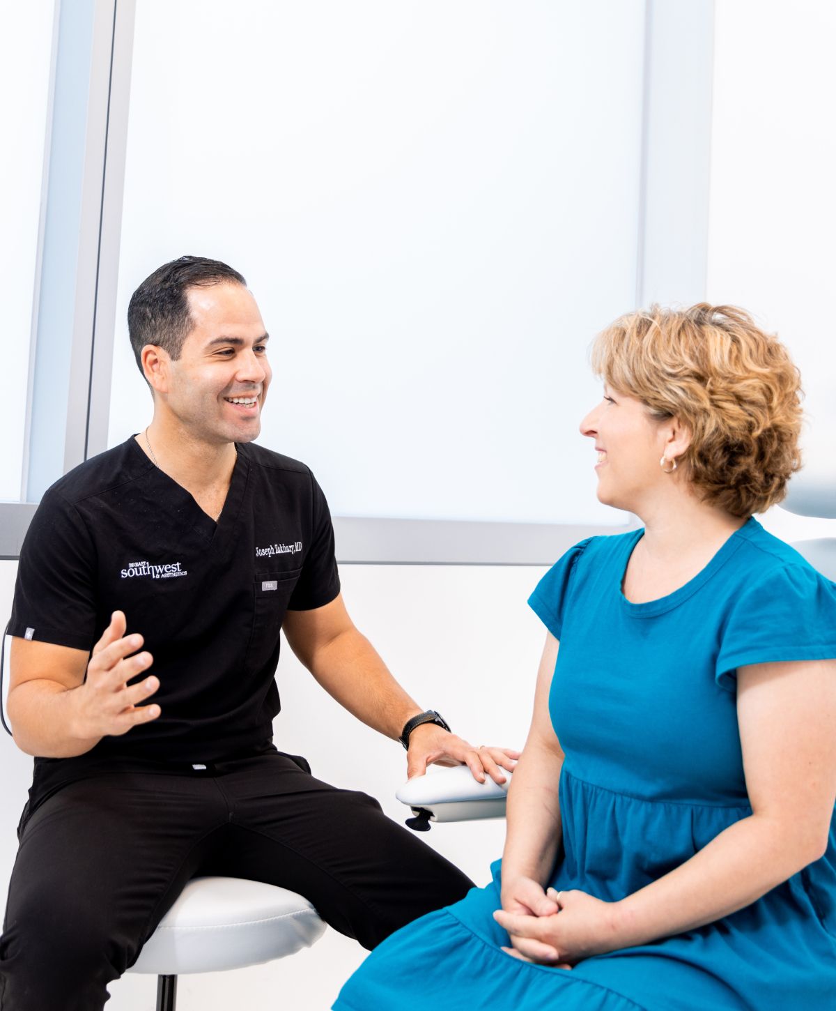 Phoenix breast reduction doctor consulting with a patient in a clinic.