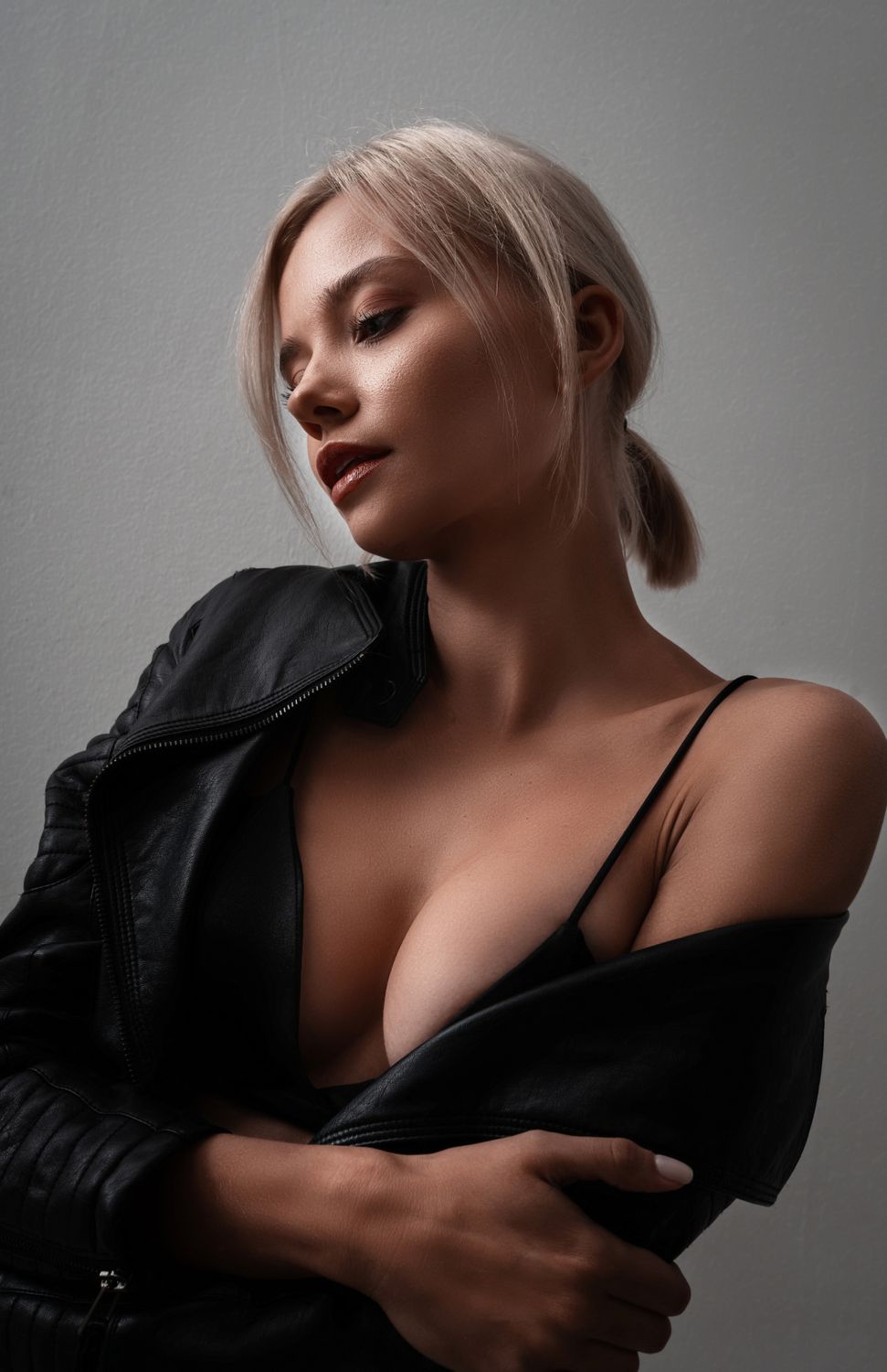 Phoenix plastic surgery model in leather jacket with stylish pose.