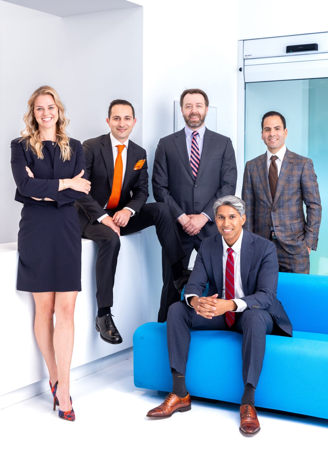 Phoenix plastic surgeons posing in a modern office.