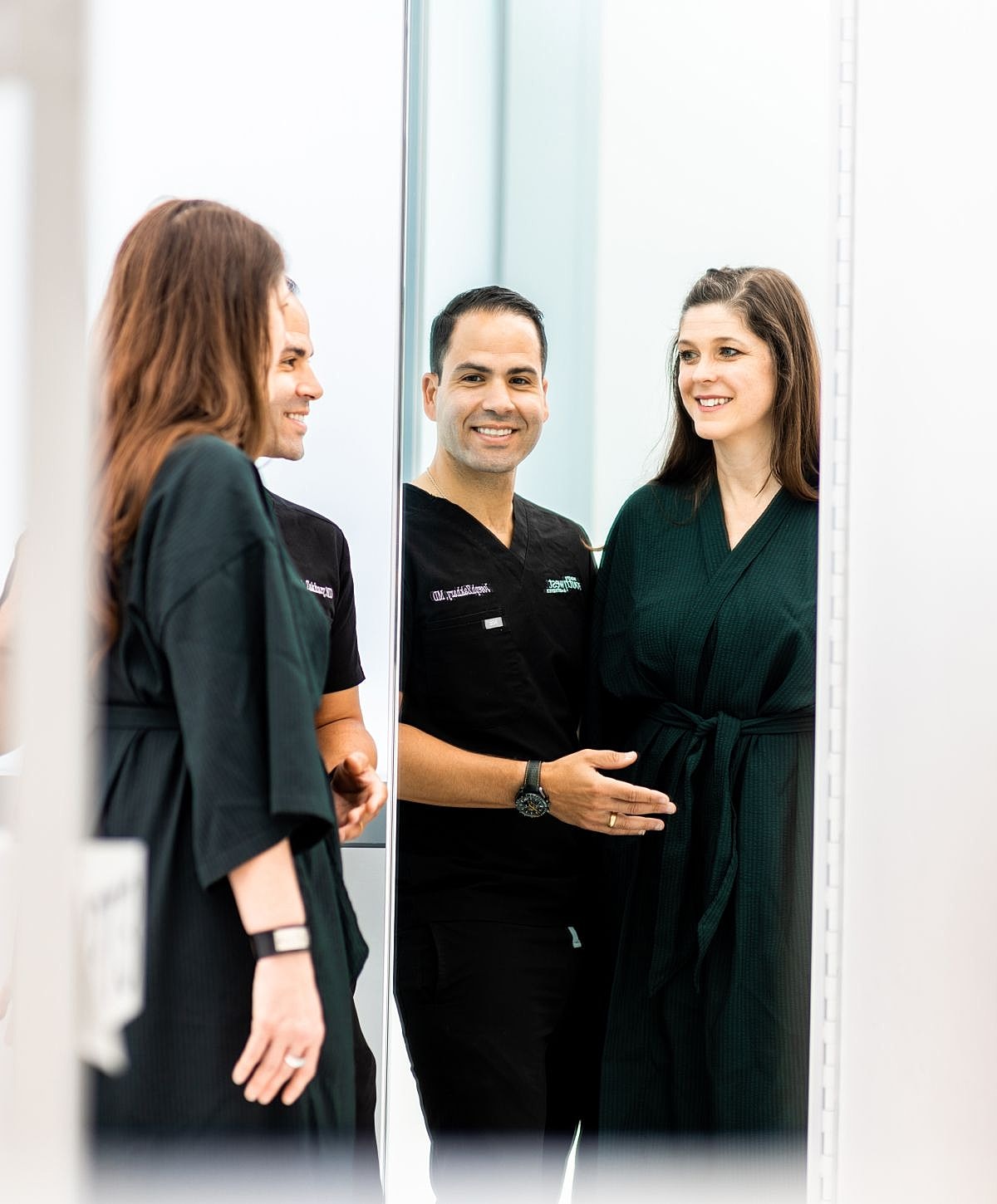Medical professional with patient in mirror reflection.