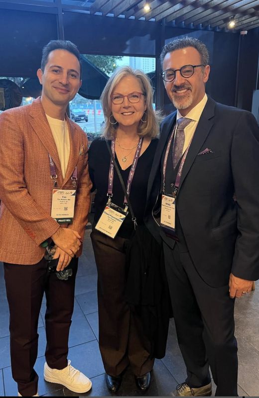 Three people posing at a professional event.