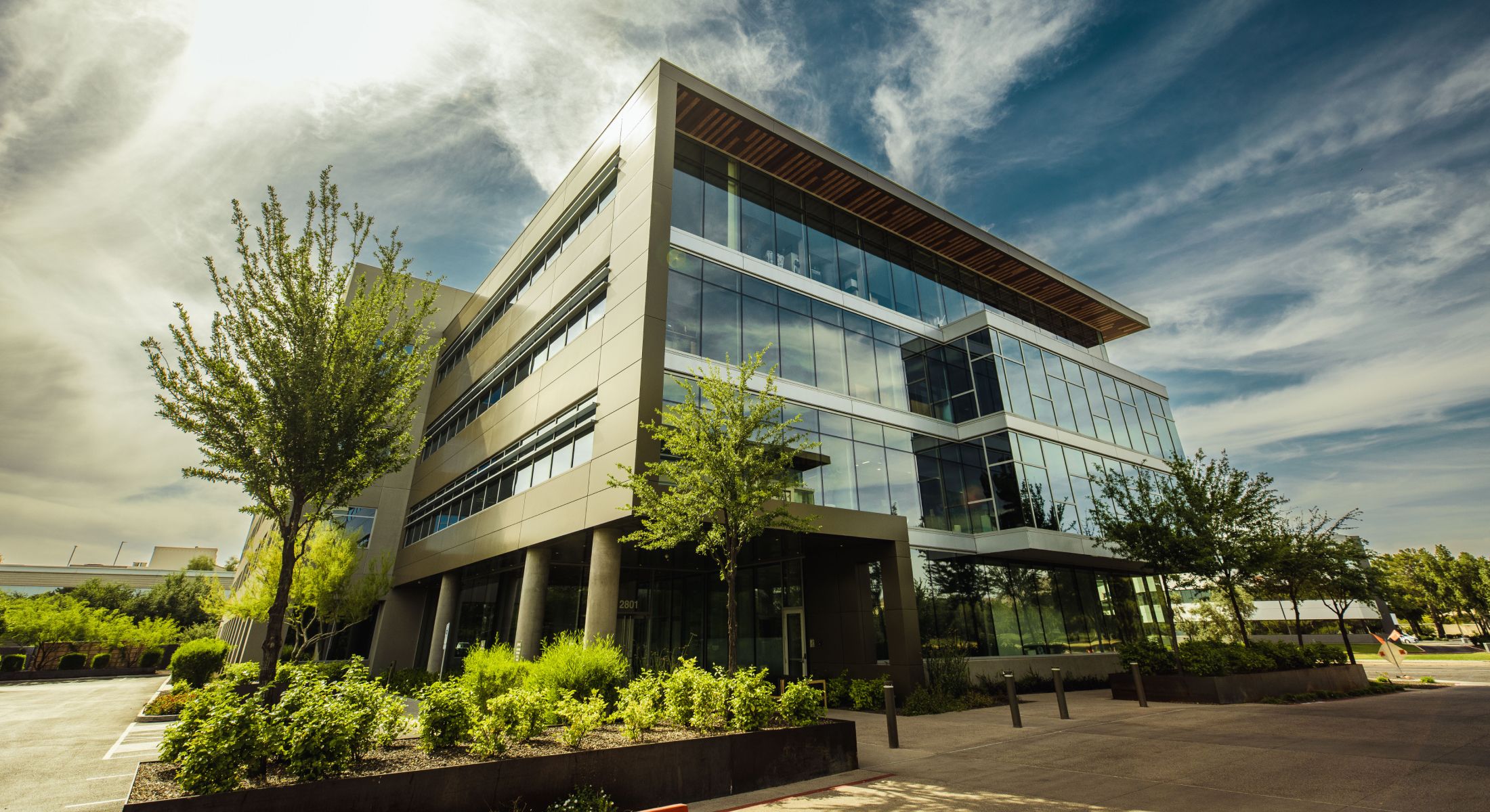 Modern office building with landscaping and blue skies.